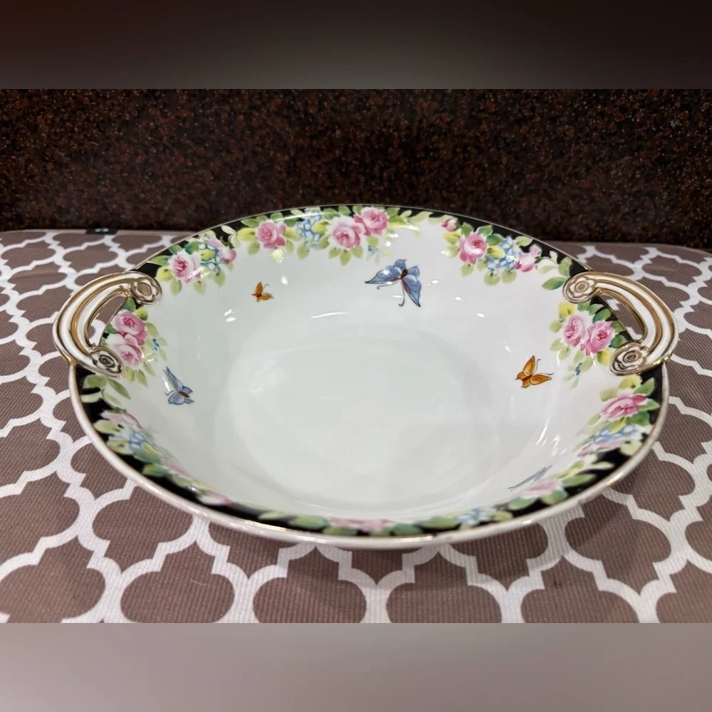 Nippon Hand-painted bowl featuring a floral motif & butterflies with gold trim